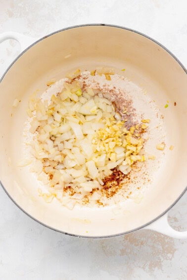 a pan with onions and garlic in it.