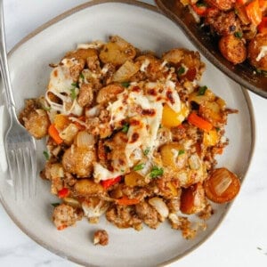 a plate of meat and vegetable casserole with a fork.