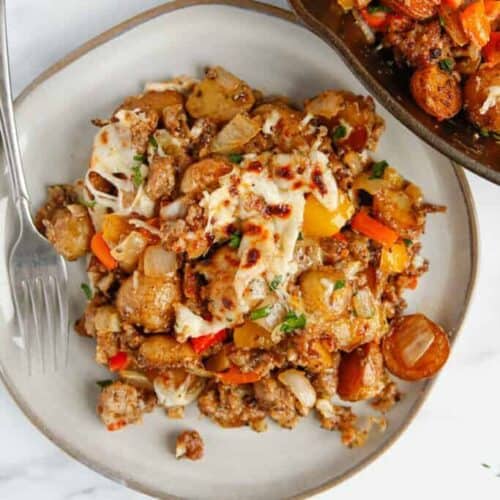 a plate of meat and vegetable casserole with a fork.