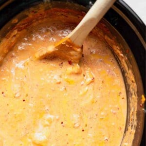 A crock pot filled with queso dip.