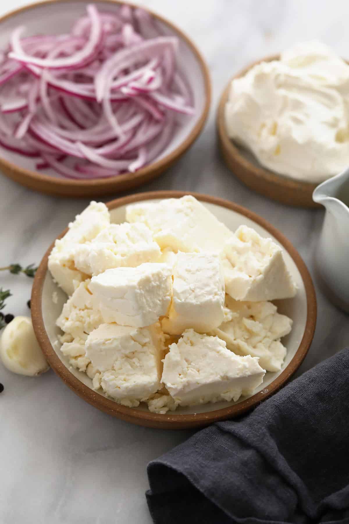 Whipped feta dip ingredients in bowls.