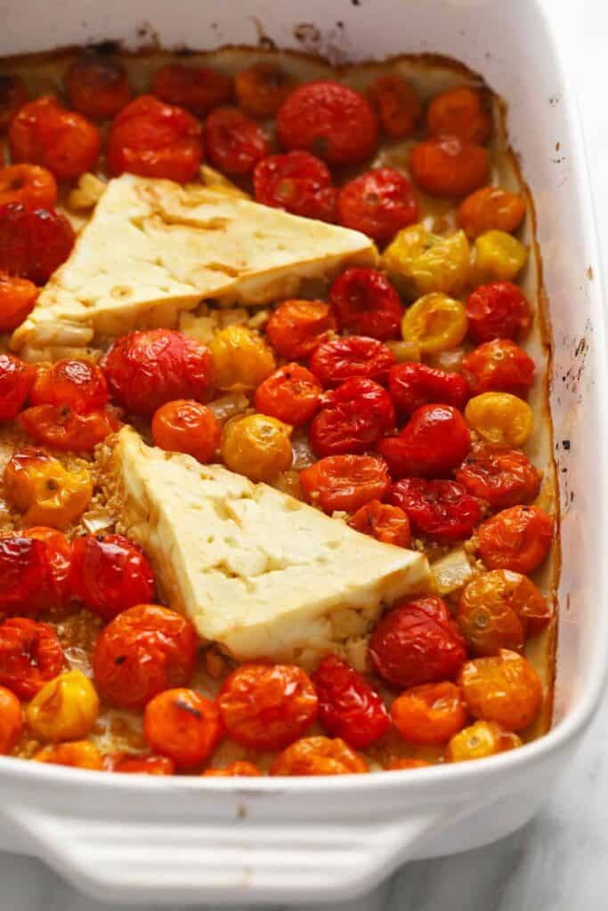 cooked tomatoes and feta cheese cooked in a baking dish
