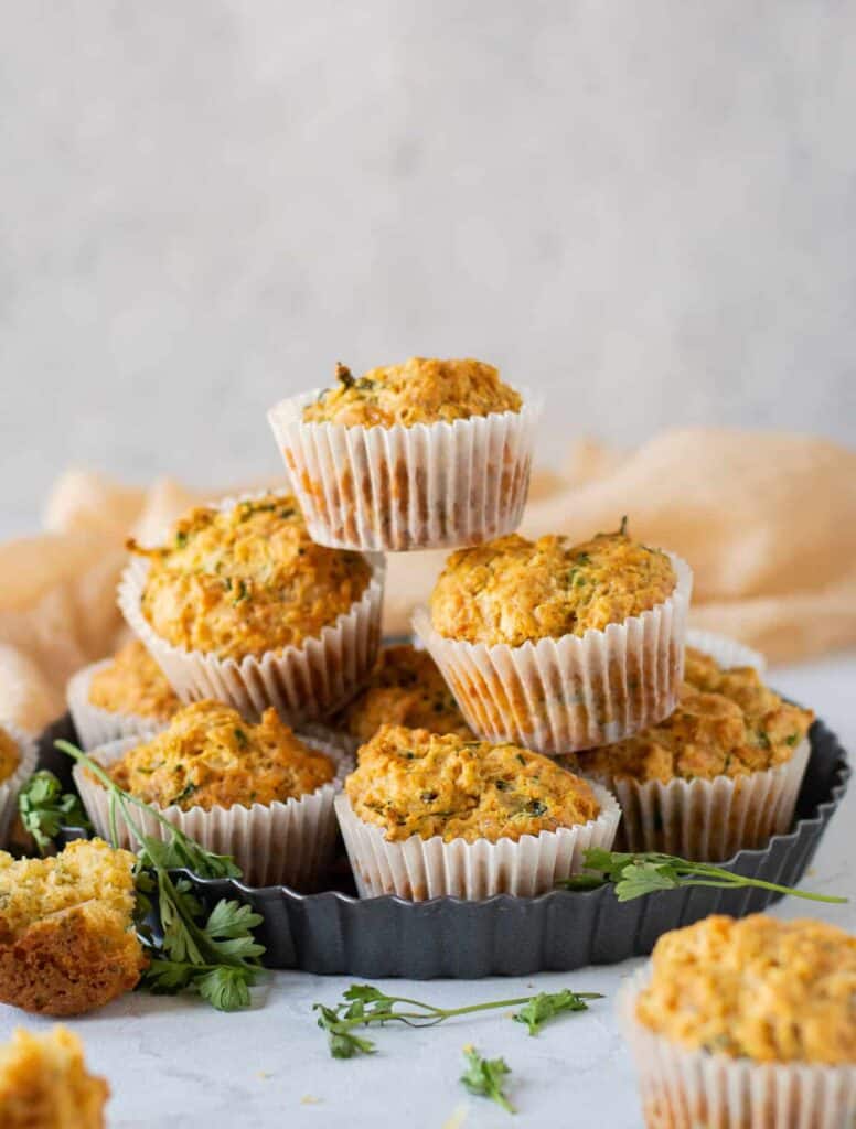 Savory cheese muffins stacked and ready to be eaten.