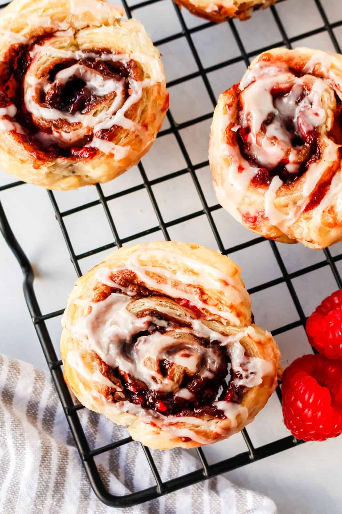 raspberry chocolate cinnamon rolls with a cream cheese glaze