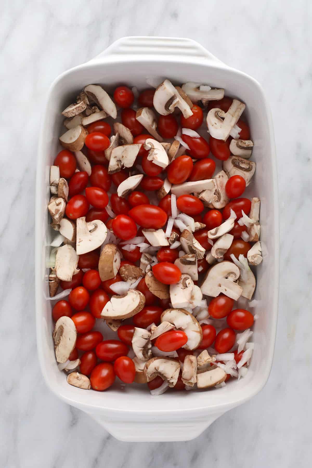 Baked cream cheese pasta sauce ingredients in a casserole dish, ready to be baked.