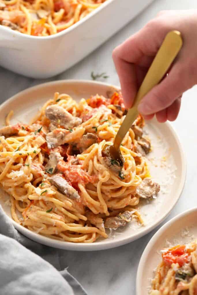 Baked cream cheese pasta being twirled on a fork.