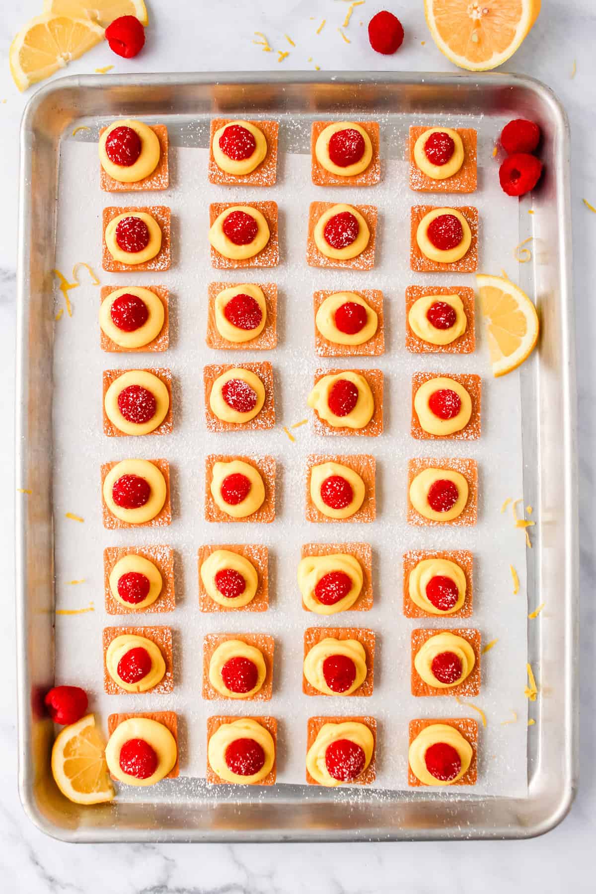 mini lemon cheesecakes on baking sheet