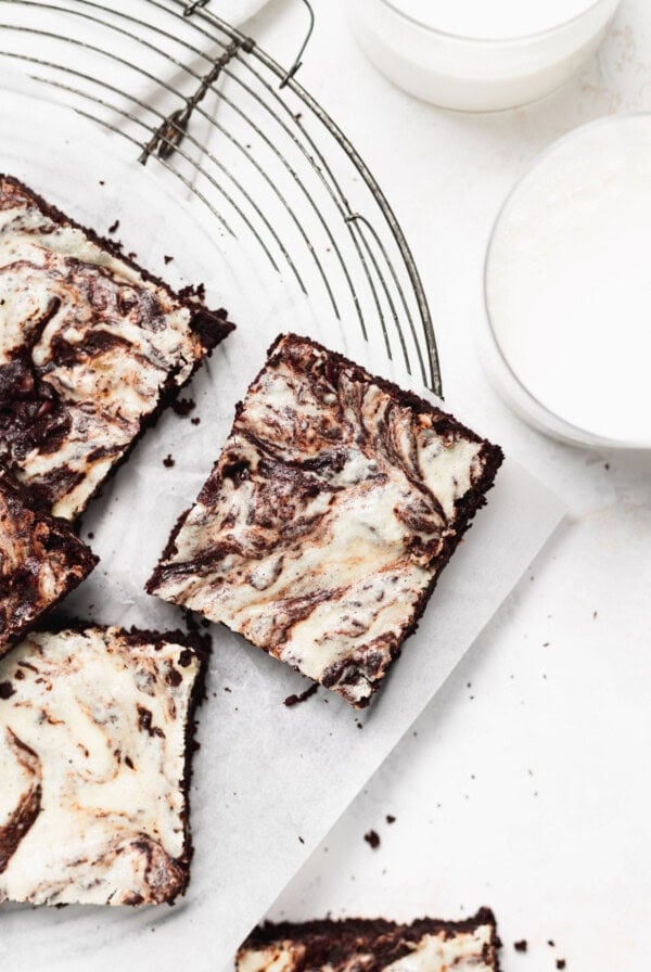 Cream cheese brownies on a cutting board.