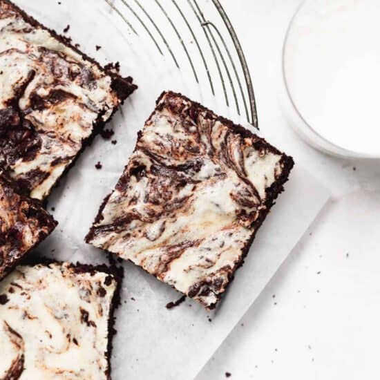 Cream cheese brownies on a cutting board.