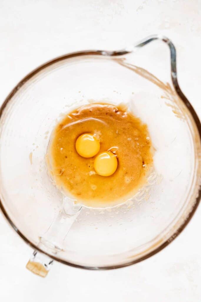 Eggs and sugar in a mixing bowl. 