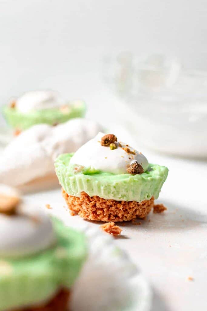 pistachio pie cup with a graham cracker crust, ready to be enjoyed