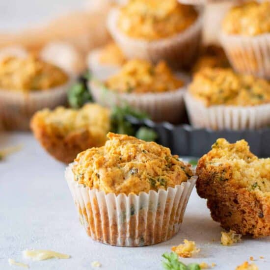 muffins with parmesan cheese and parsley on a white plate.