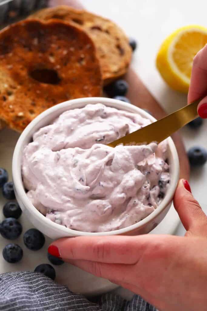 A bowl of blueberry cream cheese. 