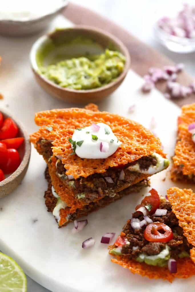 Keto quesadilla topped with Greek yogurt, red onion, and cilantro. 