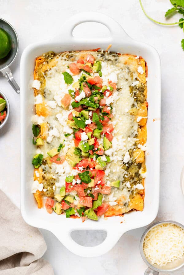 Chicken enchiladas in a casserole dish.