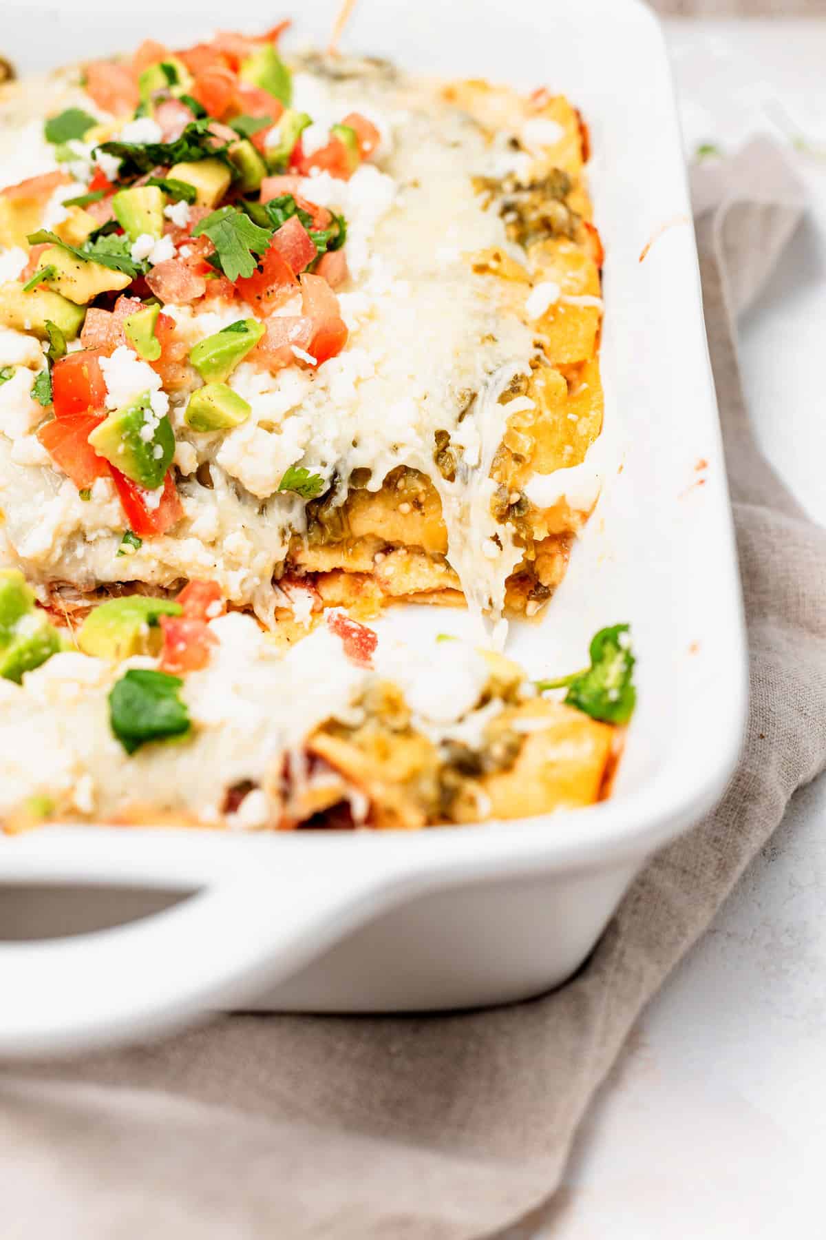 Baked enchiladas in a casserole dish. 