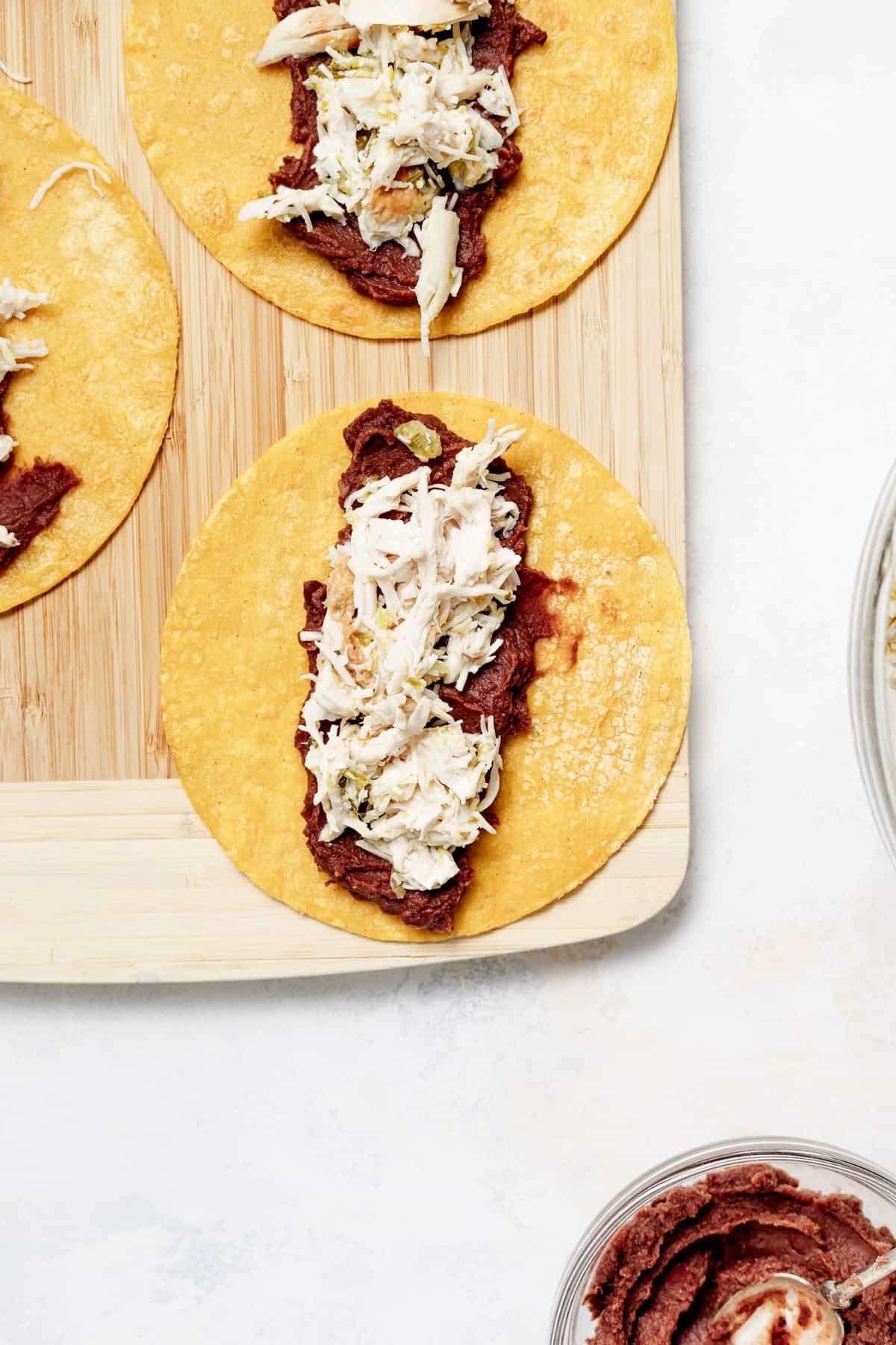 Tortillas with black refried beans and chicken. 