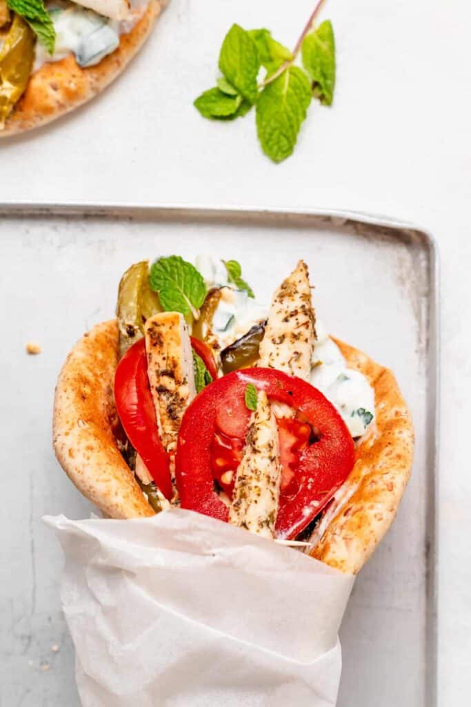 Sheet pan chicken gyros wrapped up in parchment paper. 
