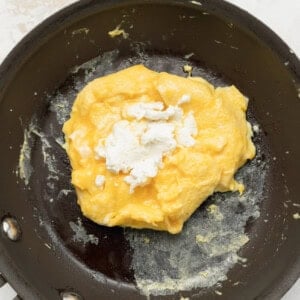 an egg is being cooked in a frying pan.