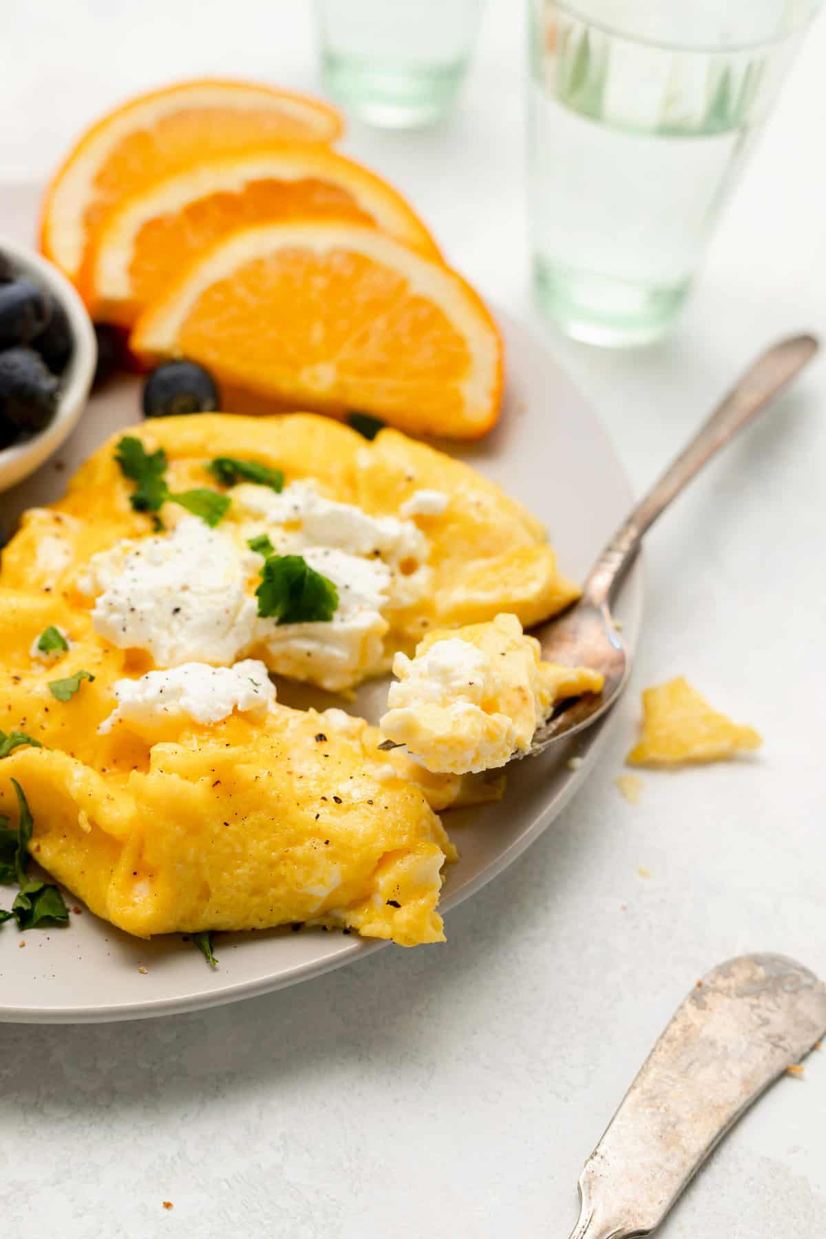 Goat cheese soft scrambled eggs on a plate. 