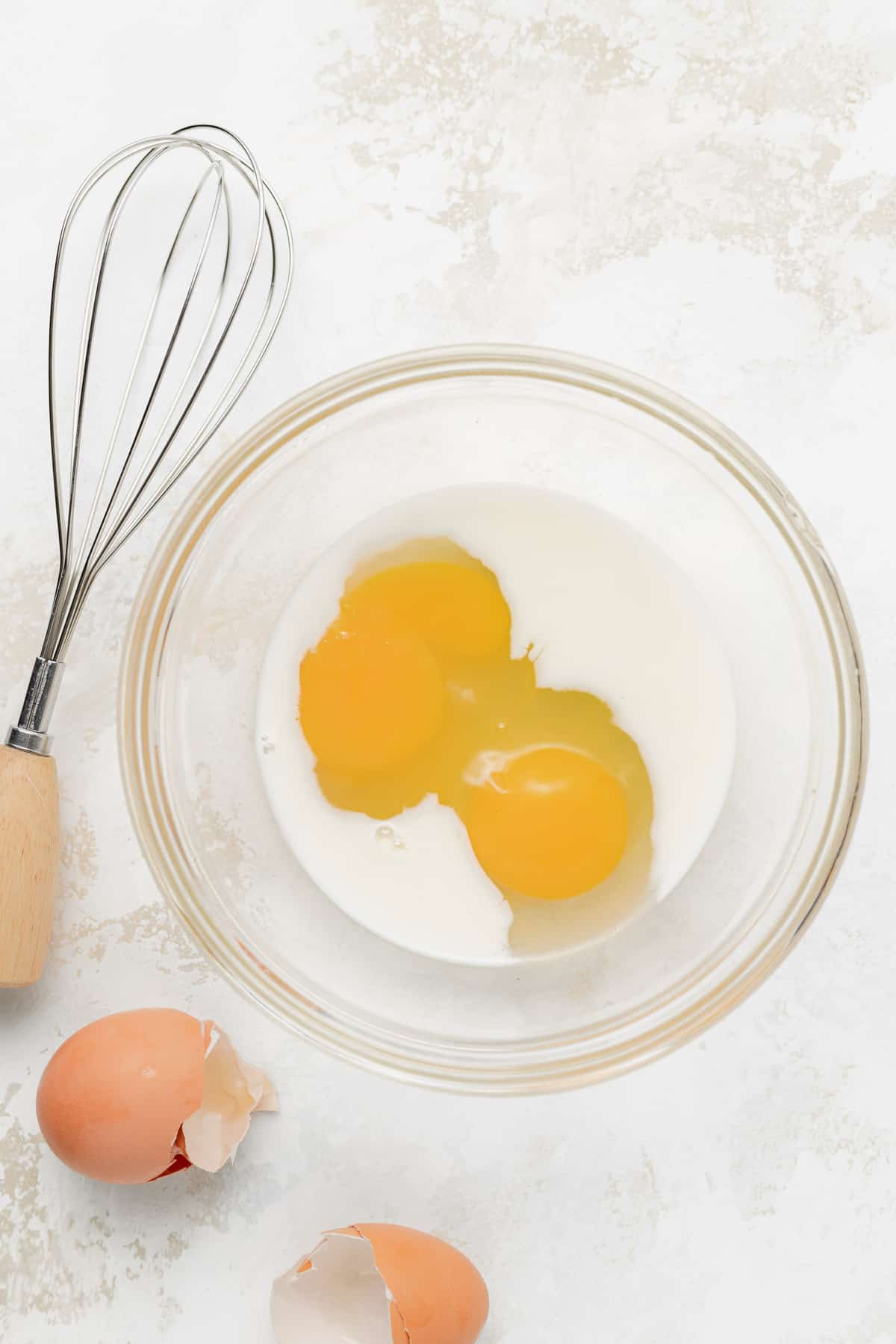 Milk and eggs in a bowl. 