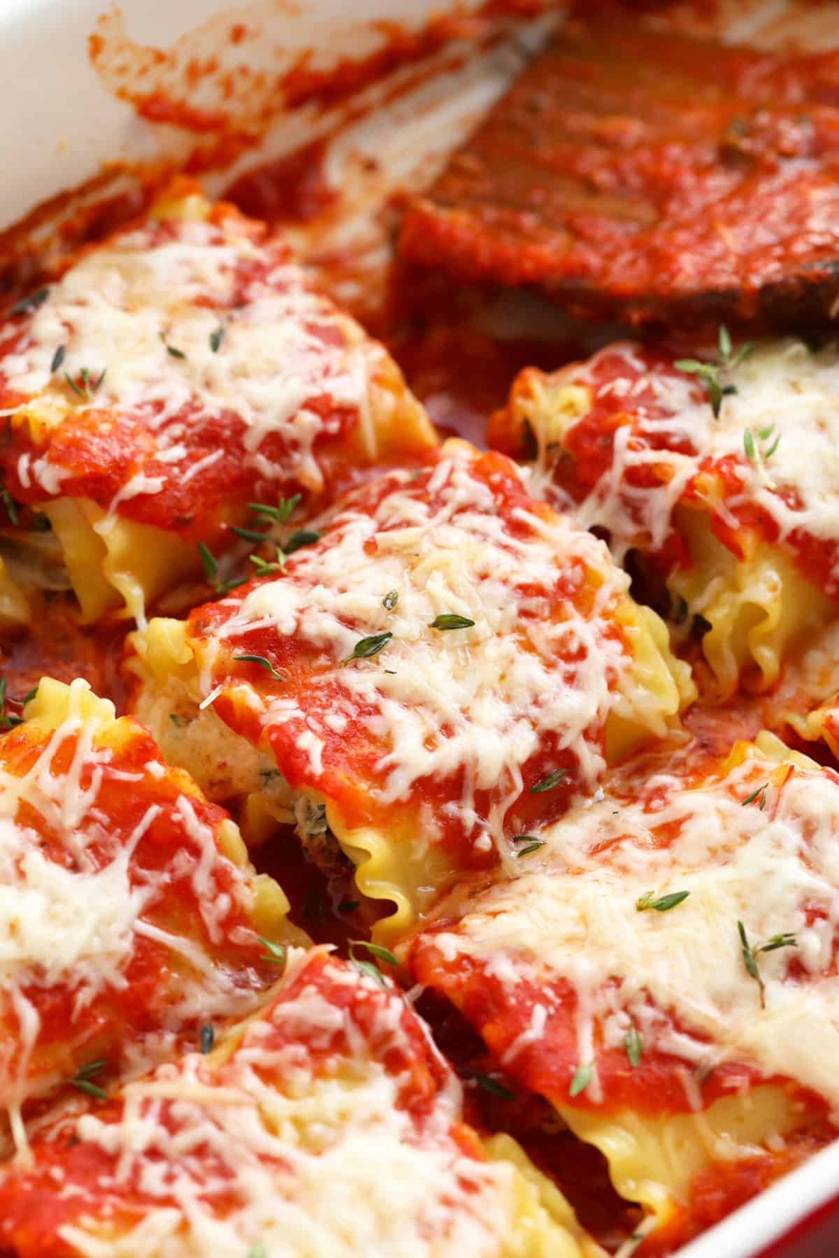 Lasagna roll ups in a casserole dish. 