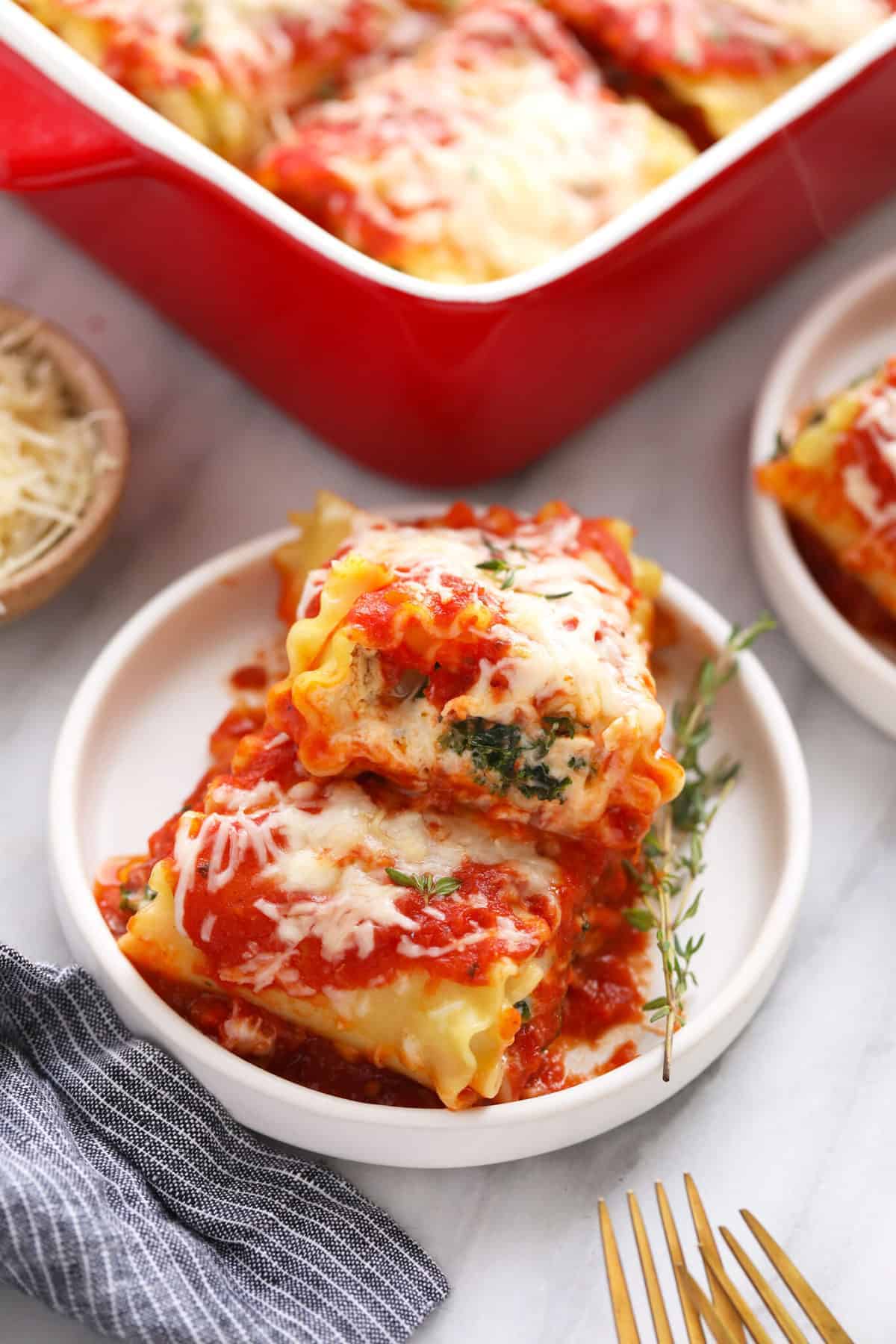 2 kale lasagna roll ups on a plate. 