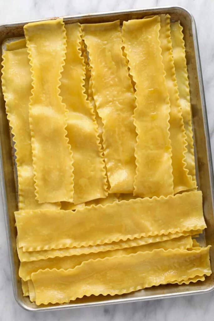 Cooked lasagna noodles on a baking sheet. 