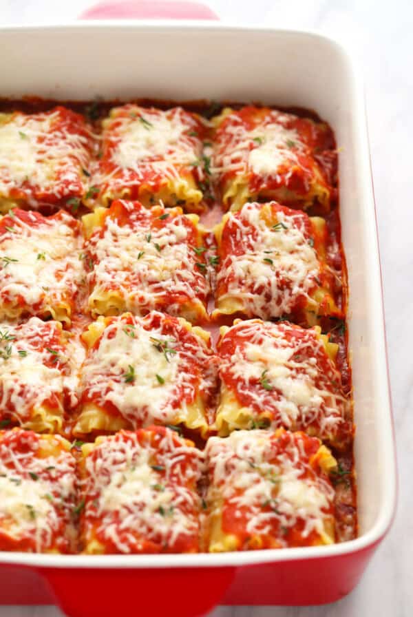 kale lasagna roll ups in a casserole dish