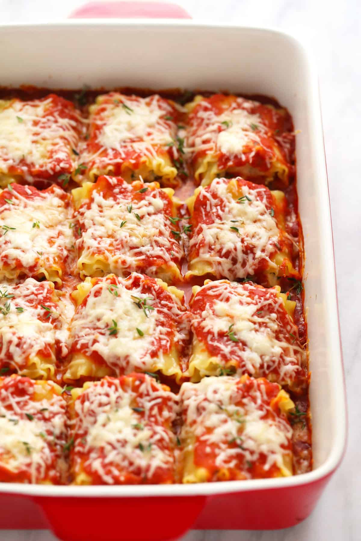 Baked Kale Lasagna Roll ups in a casserole dish. 