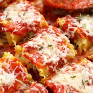 kale lasagna roll ups in a casserole dish.