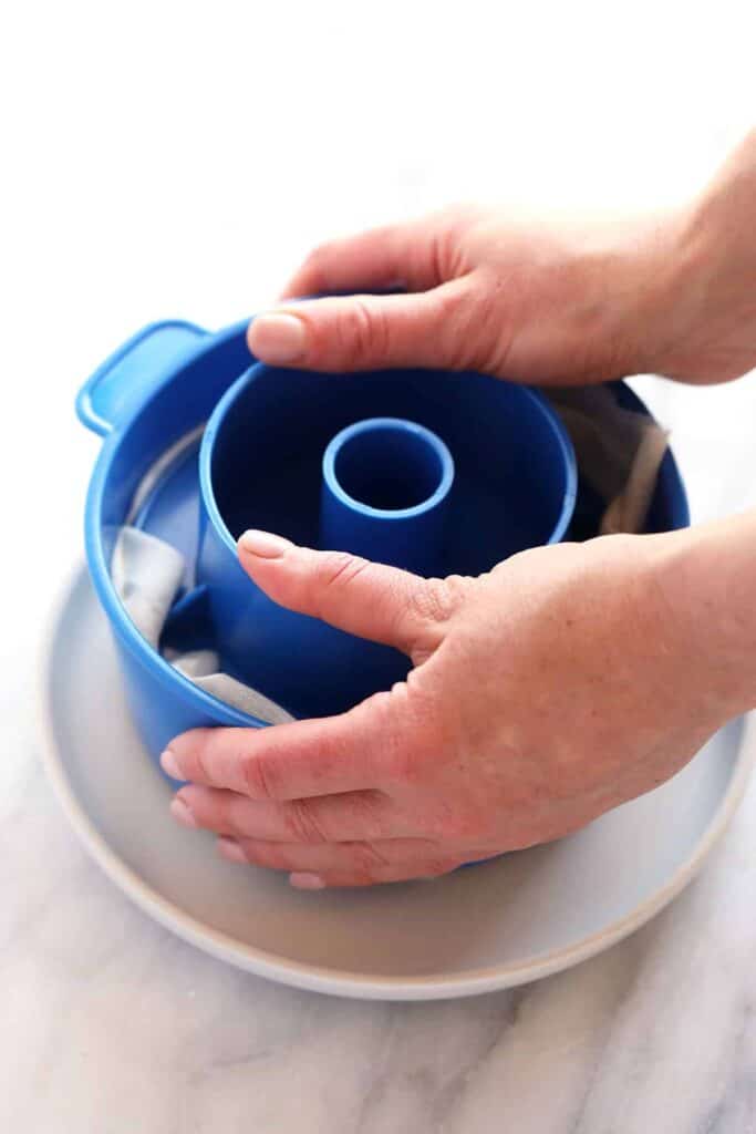 Pressing queso fresco in a cheese press. 