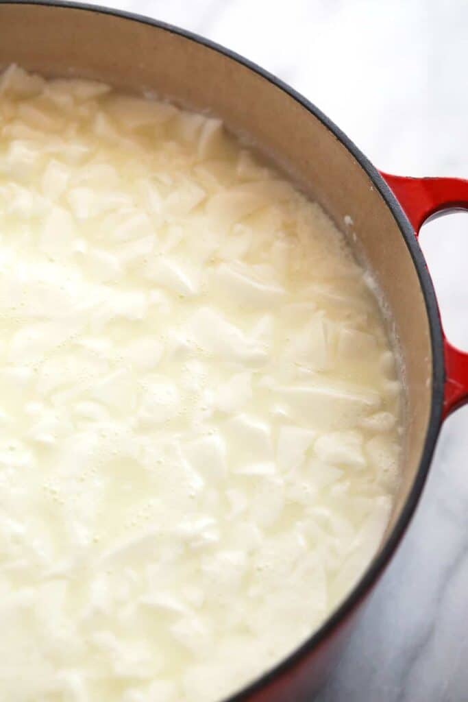 Queso fresco curds in a pot. 