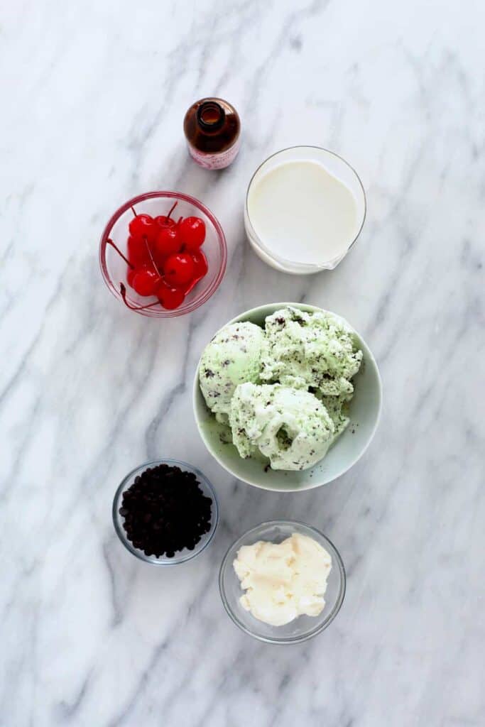 All the ingredients for a shamrock shake in bowls. 