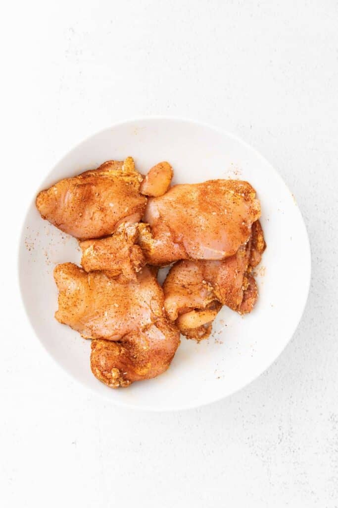 chicken wings in a white bowl on a white background.