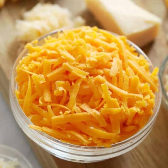 closeup of a glass bowl of shredded cheese