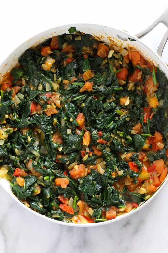 Spinach and other ingredients in a pan. 