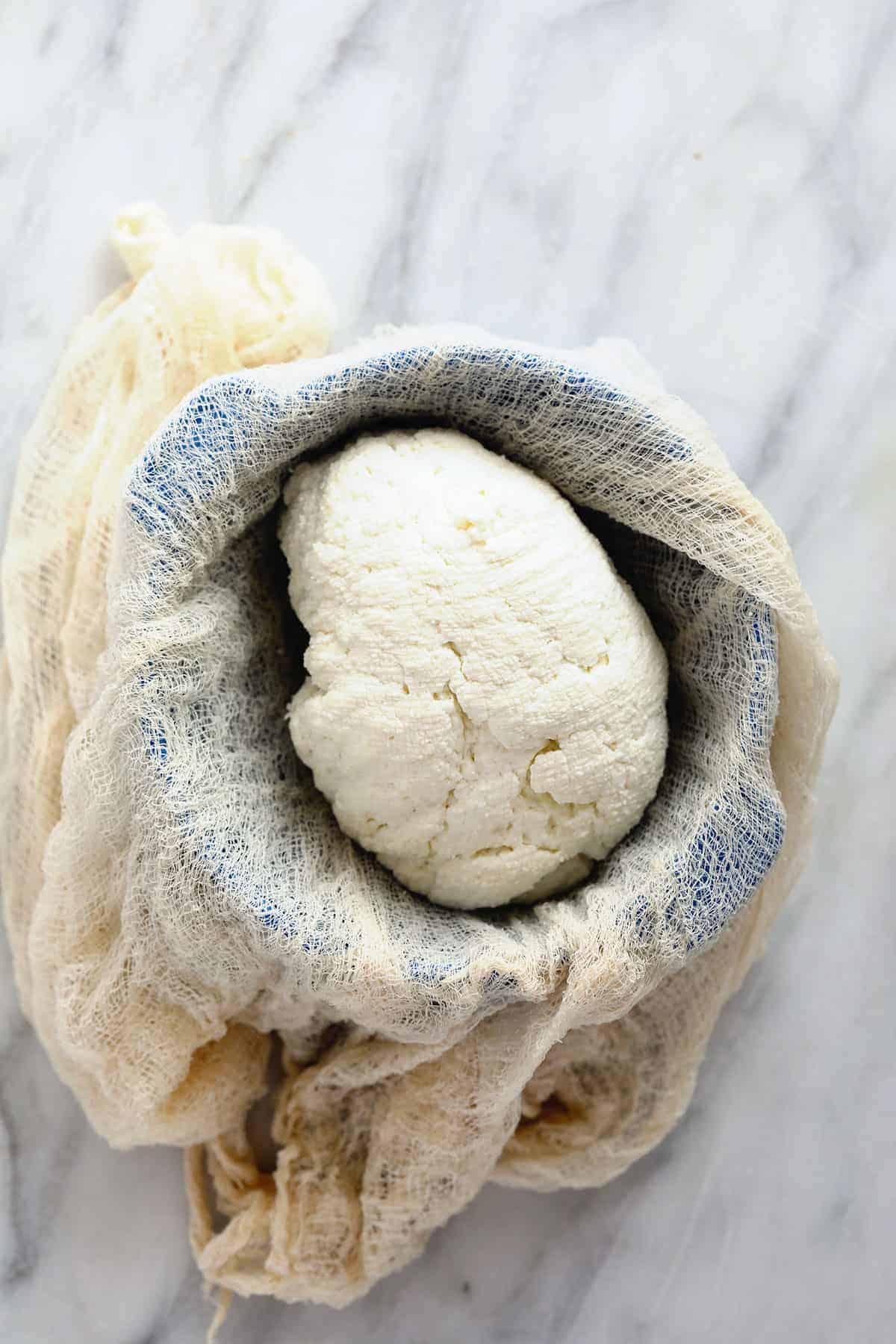 Paneer in a cheese press. 