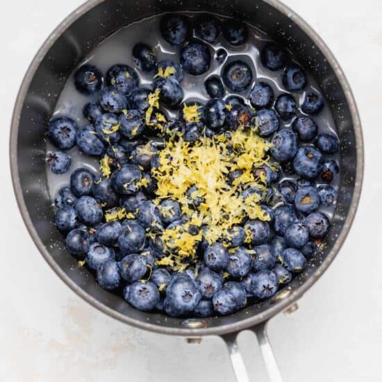 fresh blueberries and lemon zest in a saucepan.