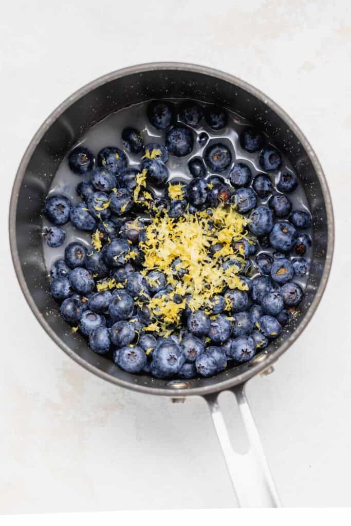 fresh blueberries and lemon zest in a saucepan.