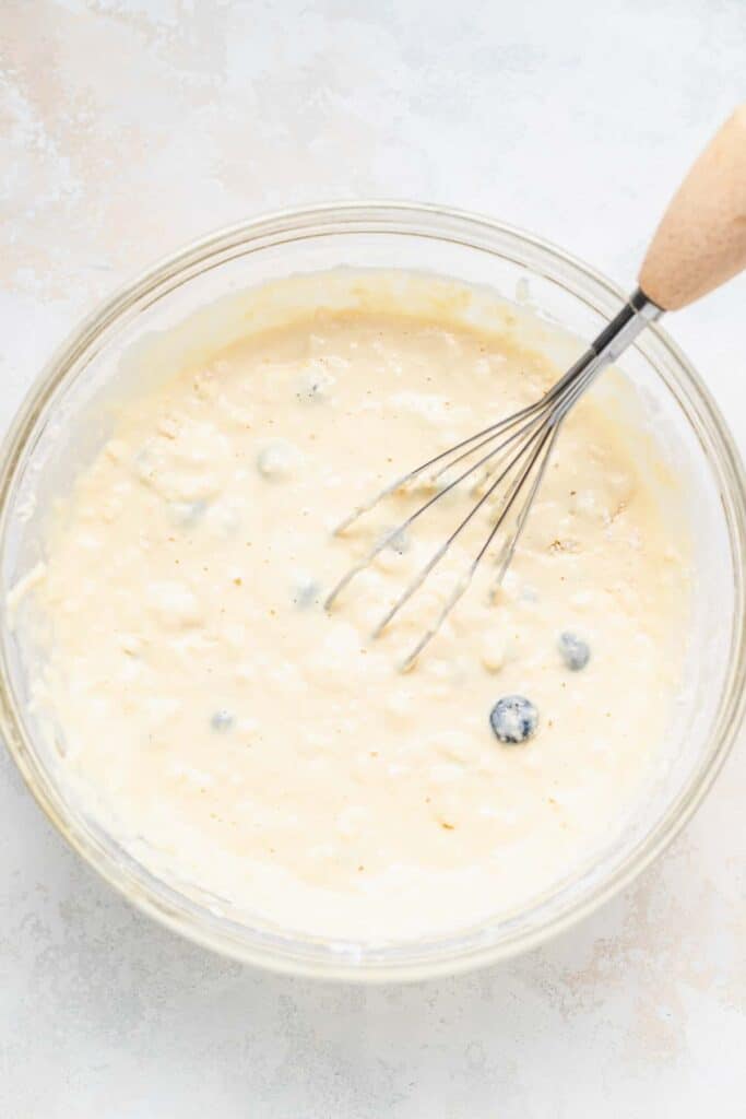 fluffy pancake batter in bowl with whisk