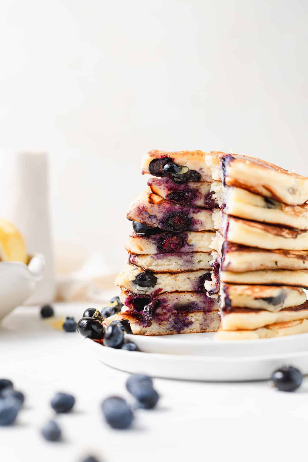 stack of ricotta pancakes with slice taken out