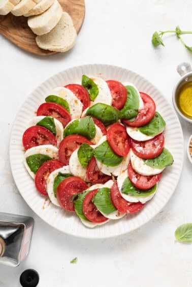 Caprese salad on a plate with fresh basil.