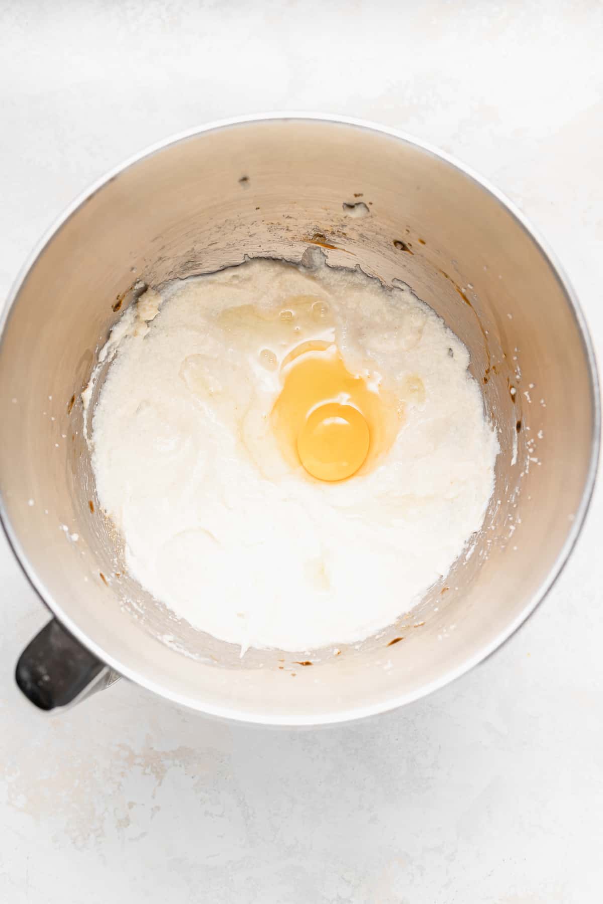 wet ingredients in a mixing bowl for chocolate chip ricotta muffins.