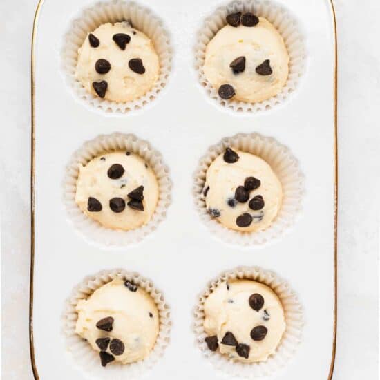Ricotta chocolate chip muffins baked in a white pan.
