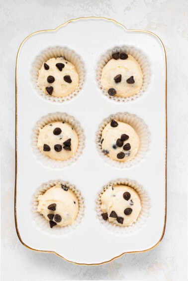 Ricotta chocolate chip muffins baked in a white pan.