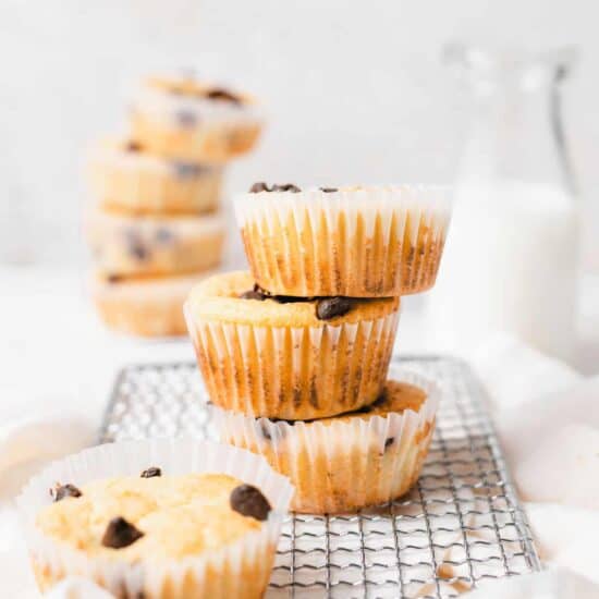 A stack of delicious chocolate chip muffins on a cooling rack.