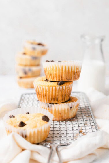 A stack of delicious chocolate chip muffins on a cooling rack.
