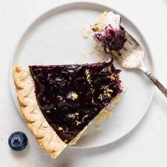 an overhead shot of a slice of blueberry cream cheese pie