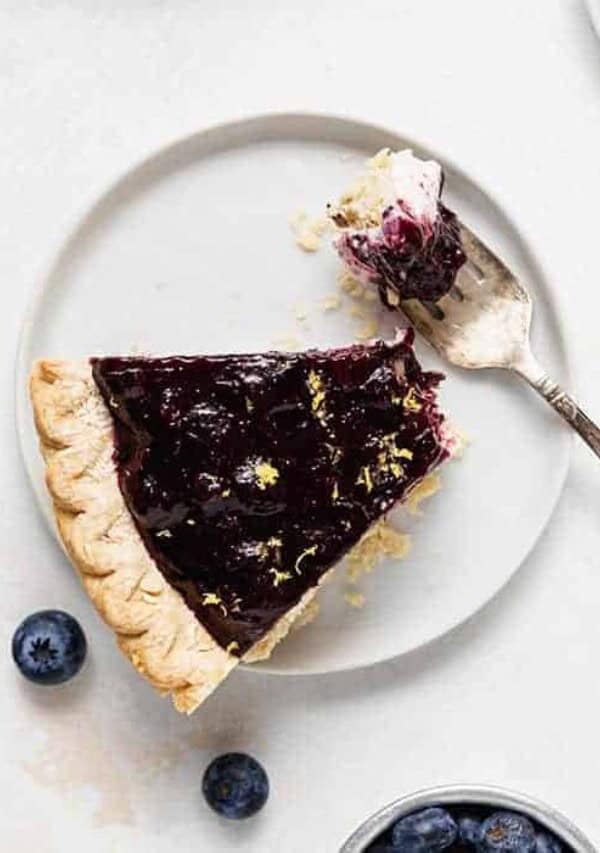 an overhead shot of a slice of blueberry cream cheese pie